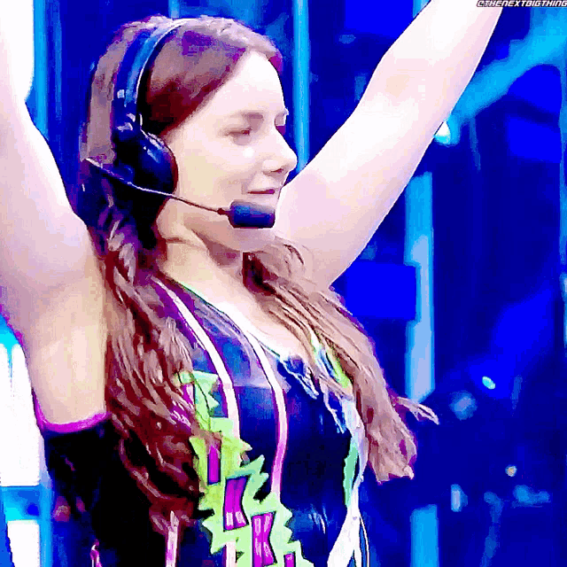 a woman wearing headphones and a microphone has the hashtag #thenextbig thing written below her