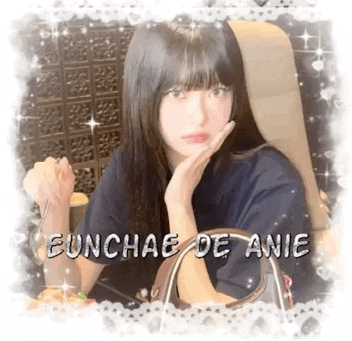 a girl with long hair is sitting in a chair with her hand on her chin and holding a purse .