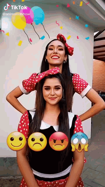 two women in minnie mouse costumes are standing next to each other with smiley faces on their chests ..
