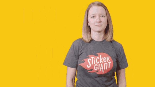 a woman wearing a sticker giant shirt is smiling