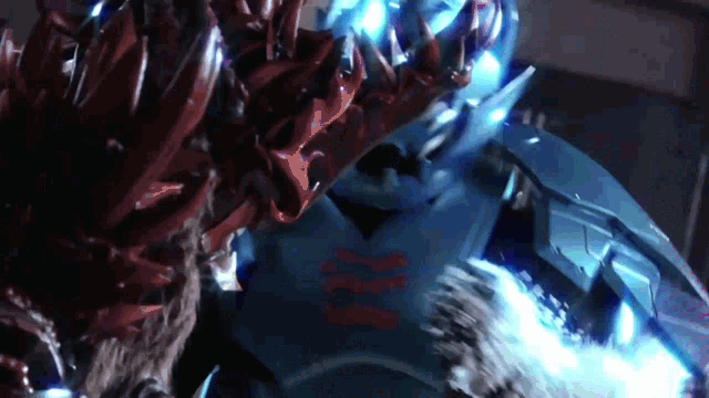 a close up of a robot with a blue light coming out of its arm
