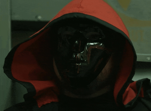 a man wearing a black mask and a red jacket