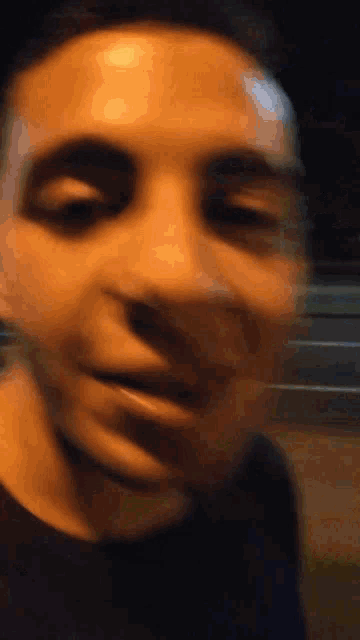 a close up of a man 's face with his mouth open and his eyes closed