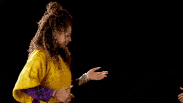 a man in a green shirt and a woman in a yellow sweater are standing next to each other