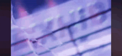 a blurry picture of a boxing ring with purple lights and a purple background .