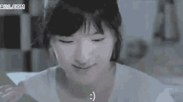 a girl with a smiley face on her face and the website a2l.com behind her