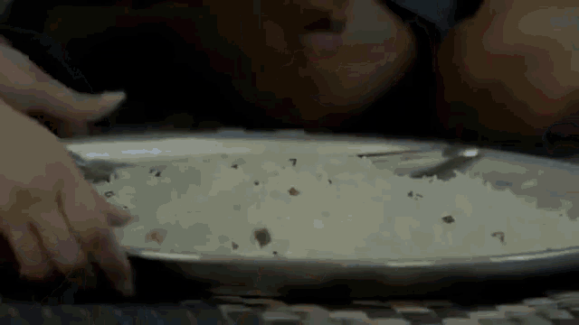 a person is holding a plate of rice with a fork .