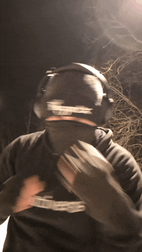 a man wearing headphones and a hoodie with the word supreme on it