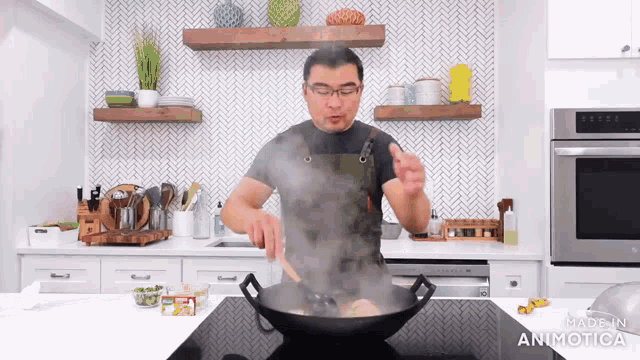 a man cooking in a kitchen with the words made in animatica on the bottom of the screen