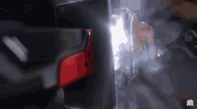 a person is welding a piece of metal with a light behind them