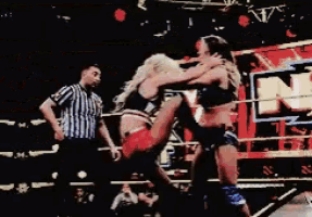 two women are wrestling in a ring in front of a sign that says nx