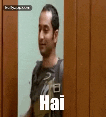 a man is standing in front of a door and waving .