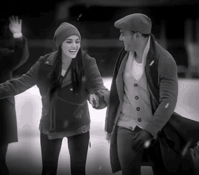 a black and white photo of a man and a woman on ice
