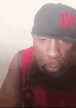 a man with a beard is wearing a hat that says ny on it