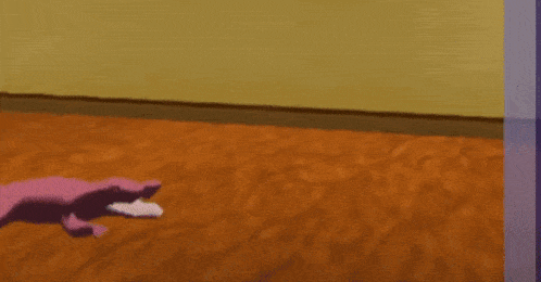 a pink lizard is laying on the floor of a hallway