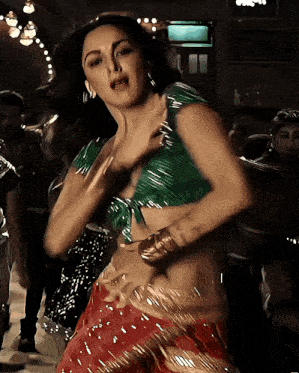 a woman in a green crop top is dancing