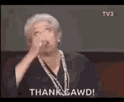 an older woman is giving a speech and says thank gawd .