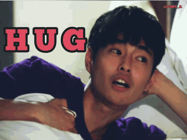 a man laying on a bed with the word hug written above him