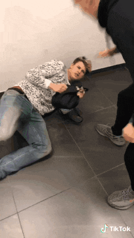 a man laying on the floor with a tiktok watermark on the bottom right