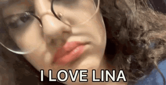 a woman wearing glasses and red lipstick is making a funny face and saying `` i love lina '' .