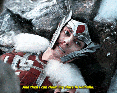 a woman in a helmet laying on the ground with the words and then i can claim my place in valhalla below her