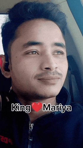 a man in a car with the words king mariya written on his face