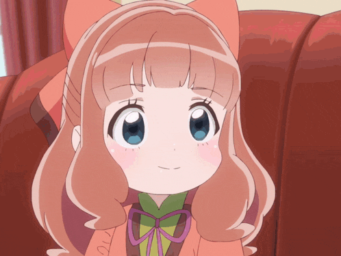 a girl with a bow on her head is smiling