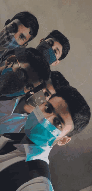 a group of young men wearing face masks pose for a picture together