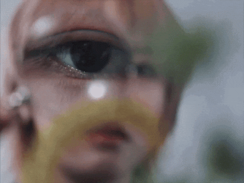 a close up of a woman 's eye with a magnifying glass on it