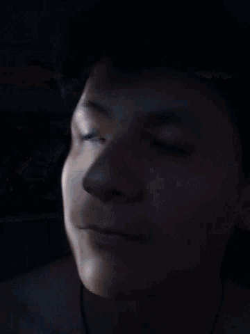 a close up of a person 's face with a serious look on their face