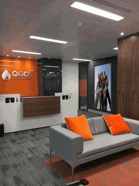 a lobby with a couch and a sign that says qgog