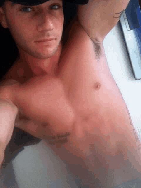 a shirtless man has a tattoo on his arm that says ' i love you '