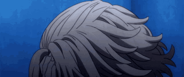 a close up of a person 's hair against a blue sky