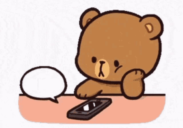 a teddy bear is sitting at a table looking at a cell phone with a speech bubble saying no spam