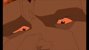 a cartoon character is laying on top of a rock with a hole in it .