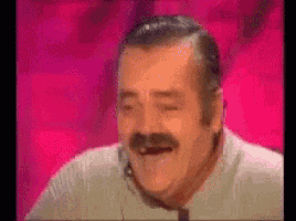 a man with a mustache is laughing with his eyes closed .