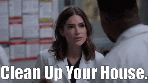 a woman in a lab coat is talking to a man in a lab coat with the words clean up your house above her