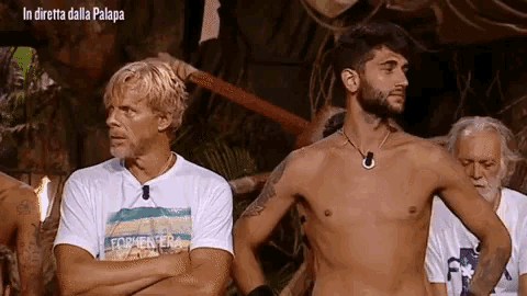a shirtless man stands in front of a group of men with the caption in diretta dalla palapa