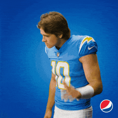 a man in a blue jersey with the number 9 on it holds his hand to his ear
