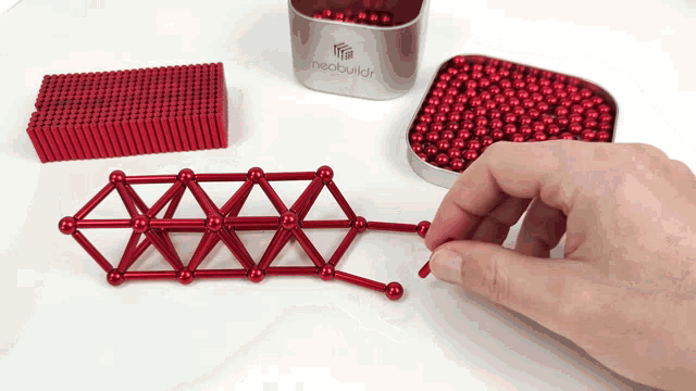 a person is playing with a neobuildr magnetic toy