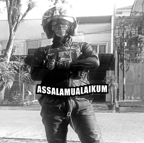 a black and white photo of a man wearing a helmet and a bandana with the words assalamualaikum written on it