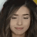 a close up of a woman 's face with her eyes closed and smiling .