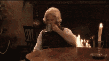 a man is sitting at a table with a candle on it