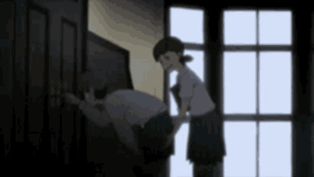 a boy and a girl are standing next to each other in a dark room .