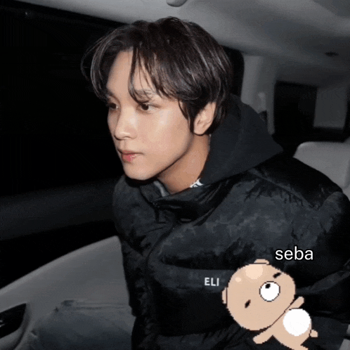 a man wearing a black jacket with eli on it