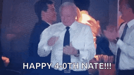a man in a suit and tie is dancing in front of a crowd of people .