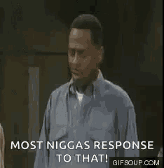 a group of people standing around a table with the words `` most niggas response to that '' written on the screen .