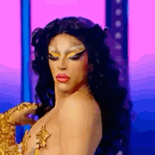 a drag queen is standing on a stage wearing a leopard print costume .