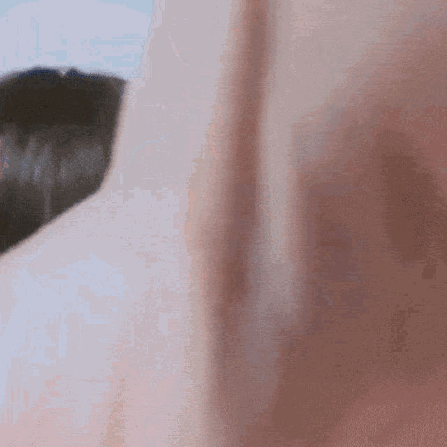 a close up of a person 's face behind a curtain