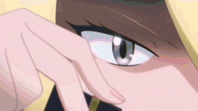 a close up of a person 's eye with a yellow hood on